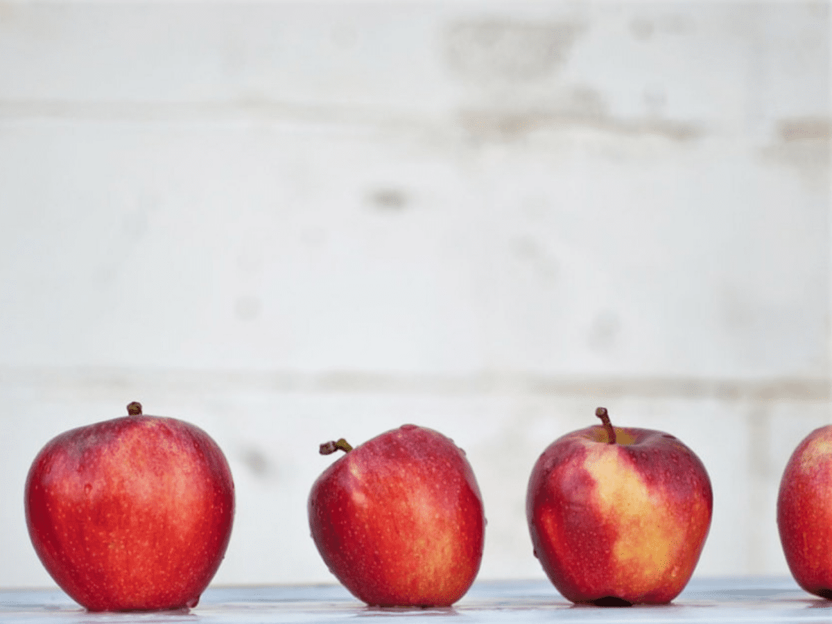 Washed apples sitting in a row