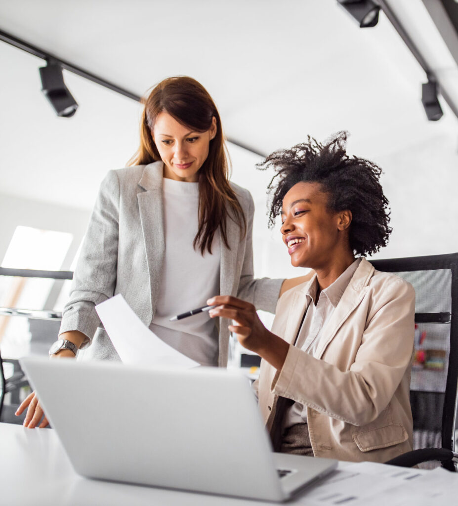 Woman showing something to another colleague.